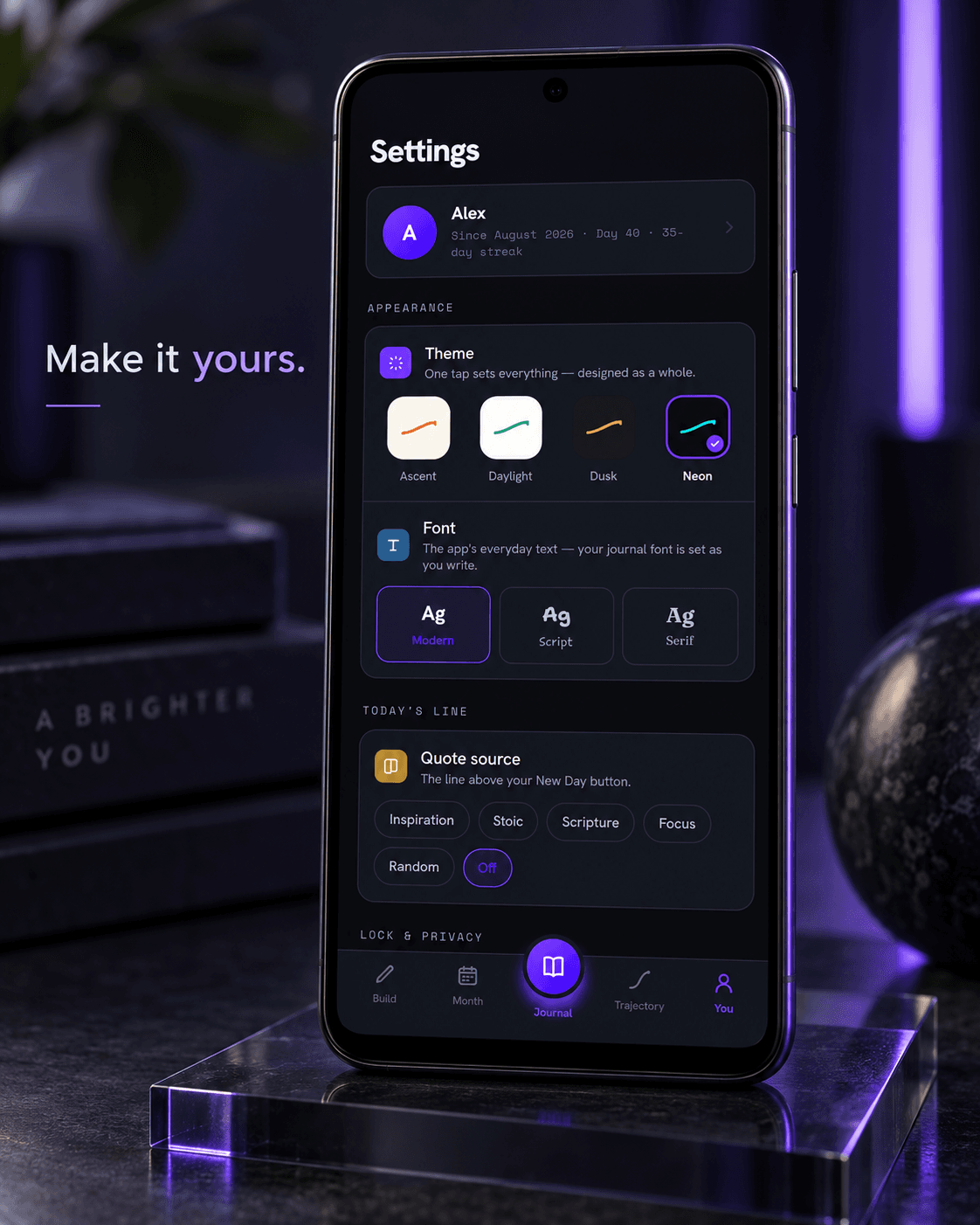Trajectory theme and font settings on an Android phone lit with violet light